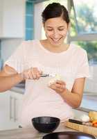 I dont want to see any skins. Shot of a young woman peeling a potato in her kitchen.