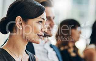 They seem pleased with the seminar. Shot of a group of businesspeople sitting in the conference room during a seminar.