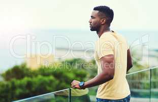 I would have never imagined Id be here one day. Shot of a handsome young man looking at the scenery while relaxing outdoors on holiday.