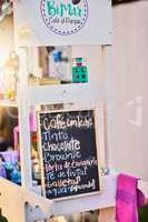 Such a great variety to choose from. Shot of a baked goods stall with a variety of goods to choose from and written down on a chalk board.