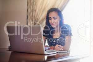 These online studying tips are really helpful. Shot of a young woman using her laptop at home.