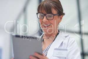 Live appointments have been a brilliant work around. Shot of a mature female doctor using a tablet.