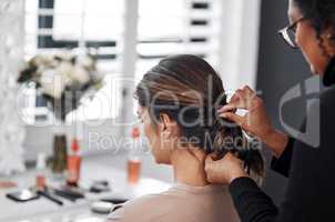 I have to look my best for this special day. Rearview shot of a woman getting her hair done by her hairstylist.