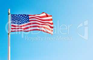 I pledge allegiance to the flag. Low angle shot of the American flag standing on its own outside during the day.