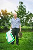 My livestock love this product. Shot of a senior man holding a bag of animal feed on a farm.