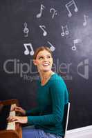 Making music. Shot of a woman playing the piano against a background of musical notes.