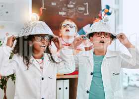 Were well known for our bright ideas. Shot of two adorable young school pupils doing an experiment about electricity and light in science class at school.