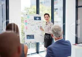 Evaluating the progress of business. Shot of a group of colleagues having a presentation at work.