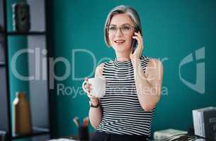 Stay positive and continue to give it your best. Shot of a businesswoman having coffee while talking on her cellphone in her office.