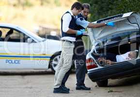 Analyzing the crime scene. Shot of a crime scene investigation in progress.