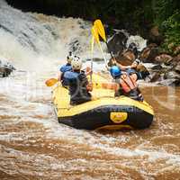 Life is about experiences. Rearview shot of a group of young friends white water rafting.