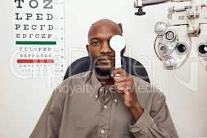 Get your eyes tested for the health of it. Shot of a young man covering his eye with an occluder during an eye exam.