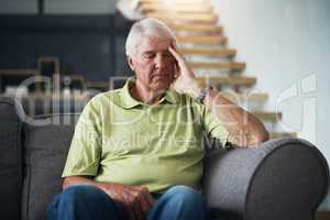 What could be causing these headaches. Shot of a senior man suffering from a headache at home.