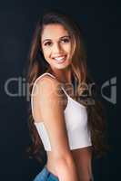 Boost your self confidence with a smile. Studio portrait of an attractive young woman posing against a dark background.