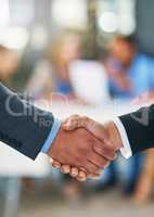 Merging together. Shot of businesspeople shaking hands.