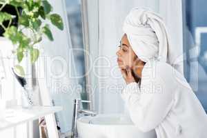 My daily beauty routine. Shot of a young woman going through her beauty routine at home.