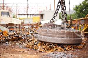 Power of magnetics. Cropped shot of a large magnet collecting garbage at a scrapyard.