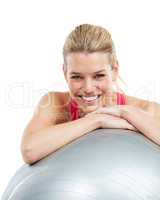 Love yourself a little more. Studio shot of a young woman leaning on her exercise ball.