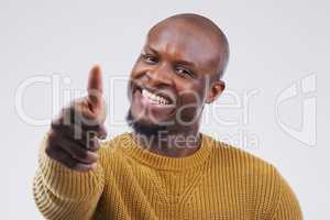 Im happy to agree. Studio portrait of a handsome young man giving a thumbs up against a grey background.