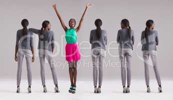 Be the best version of yourself. Studio shot of a woman in a colorful outfit standing out from the crowd.