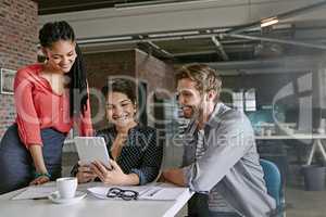 Were making great headway on the project. Shot of a group of colleagues having a brainstorming session in a modern office.