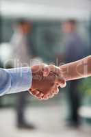 Sealing the deal with a handshake. Closeup shot of businesspeople shaking hands in an office.