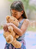 Teddy offers her the comfort she needs. Cropped shot of a little girl kissing her teddy bear.