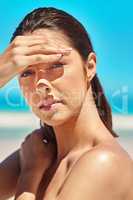 The heat is on. Shot of a beautiful young woman at the beach.