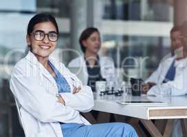 Its always great to catch up with coworkers. Shot of a female doctor sitting down to take a break from her work.