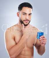 The scent that matches my style. Studio shot of a handsome young man applying cologne against a grey background.