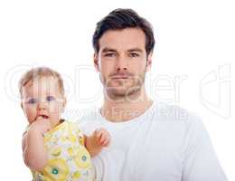 Fatherhood suits him. Portrait of a proud young dad standing with his lovely baby daughter in his arms.