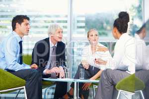 Discussion between business people. Portrait of multi racial business group discussing together at office.