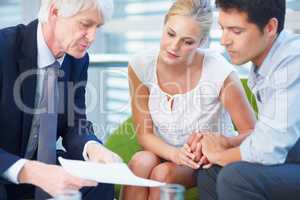 Couple with consultant. Portrait of couple discussing financial matter with consultant.