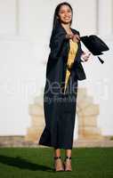 My aim is to soar even higher. Shot of a young woman tossing her hat into the air on graduation day.