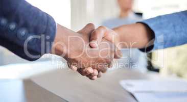 This merger is going to lead to big things. Closeup shot of two unrecognisable businessmen shaking hands in an office.