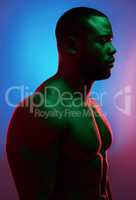Challenges only make you stronger. Studio shot of a man posing shirtless against a neon background.