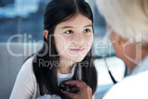 Children are not things to be molded. Shot of a little girl getting a checkup at the clinic.