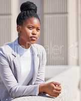 Dreaming up ways to achieve my goals. Shot of a young businesswoman taking a break to daydream.