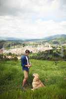 No leash required. Full length shot of a handsome young man taking his dog for a walk in the mountains.