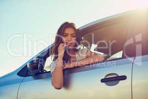 Ready for the next destination. Portrait of a young woman sitting in her car.