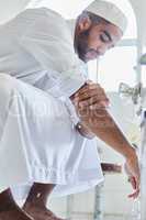 Cleanse the outside before the inside. Shot of a young man washing his hand in a mosque.