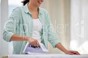 Im going to look stunning in this. Shot of a happy woman ironing her clothing.