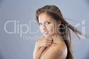 Just a stunning young woman. Head and shoulders studio shot of a beautiful young woman against a blue background.