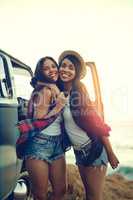 Everybody needs a road trip buddy and shes mine. Shot of two affectionate friends stopping at the beach during their roadtrip.