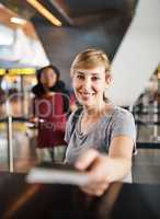 Here you go. Cropped portrait of an attractive young woman handing over her passport at a boarding gate in an airport.