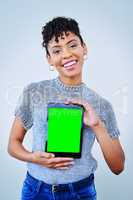 Read up about me on here. Portrait of an attractive young woman holding up a digital tablet against a blue background.
