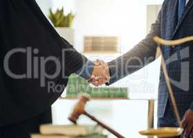 Lets fight injustice together. Shot of two unrecognizable lawyers shaking hands at work.