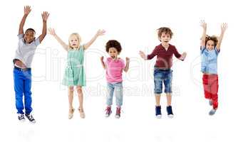 Lets take happiness to new heights. Studio shot of a group of young friends jumping for joy against a white background.