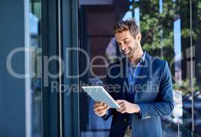 Keeping track of meetings. Shot of a young businessman busy on a digital tablet.