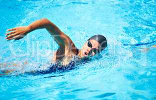 Taking a deep breath.... Female swimmer doing freestroke in a pool.